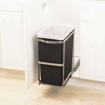 Detail view of Simplehuman 30L Pull-Out Can, Polished Stainless Steel frame holding black liner, fully extended under cabinet.
