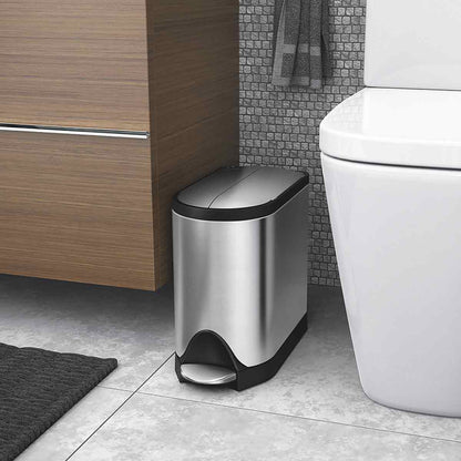 Lifestyle view of Simplehuman 10L Butterfly Step Can in Brushed Stainless Steel, narrow space-saving fit, hands-free pedal.