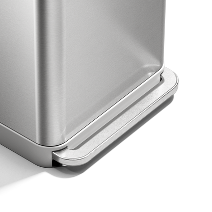 Close-up of Simplehuman 55L Rectangular Step Can brushed stainless steel pedal, hands-free design.