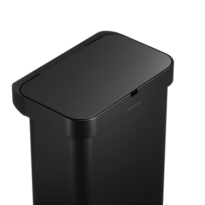 Detail view of Simplehuman 58L Sensor Can Matte Black top surface, showing touch-free sensor.
